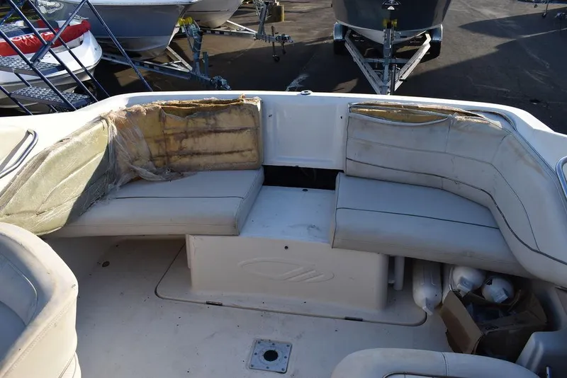 Slide: The Image of 1999 Maxum 2300SC boat interior with worn seating and storage compartment. - 17