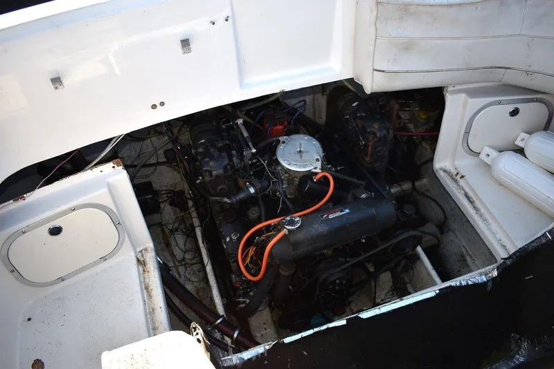 Slide: The Image of Engine compartment of a 1999 Maxum 2300SC boat, showing detailed mechanical components. - 19
