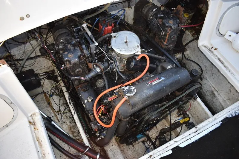 Slide: The Image of Engine compartment of a 1999 Maxum 2300SC boat, showing detailed mechanical components. - 20