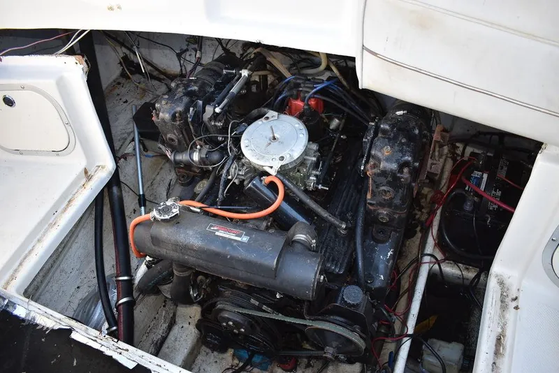 Slide: The Image of Engine compartment of a 1999 Maxum 2300SC boat, showing detailed mechanical components. - 21