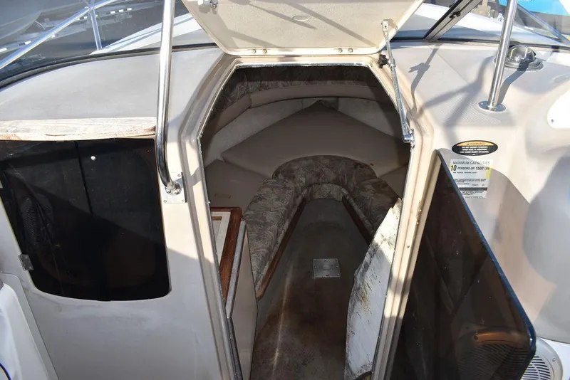 Slide: The Image of 1999 Maxum 2300SC boat cabin interior with seating and storage. - 23