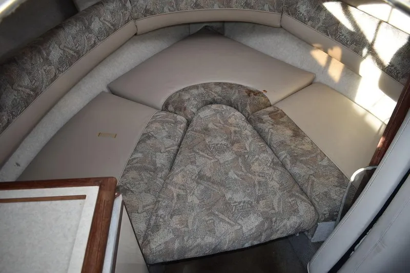 Slide: The Image of 1999 Maxum 2300SC cabin interior with patterned cushions and compact layout. - 25