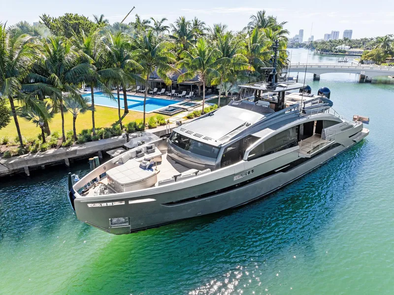 Slide: The Image of Luxury Pershing GTX 116 yacht, 2023 model, docked near tropical palm trees and a pool. - 16