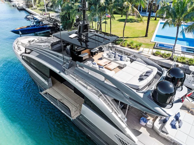 Slide: The Image of Luxurious 2023 Pershing GTX 116 yacht docked by a tropical waterfront estate. - 17