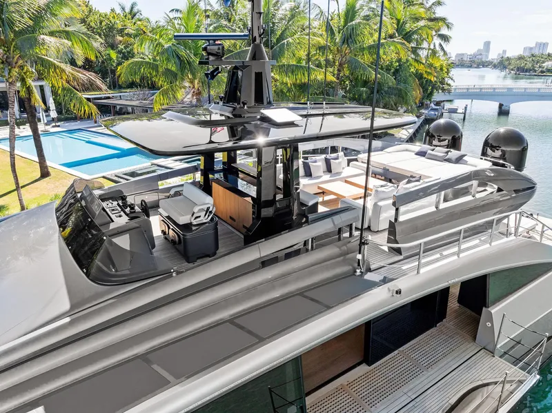 Slide: The Image of Luxurious 2023 Pershing GTX 116 yacht with sleek design, docked near tropical palm trees. - 18