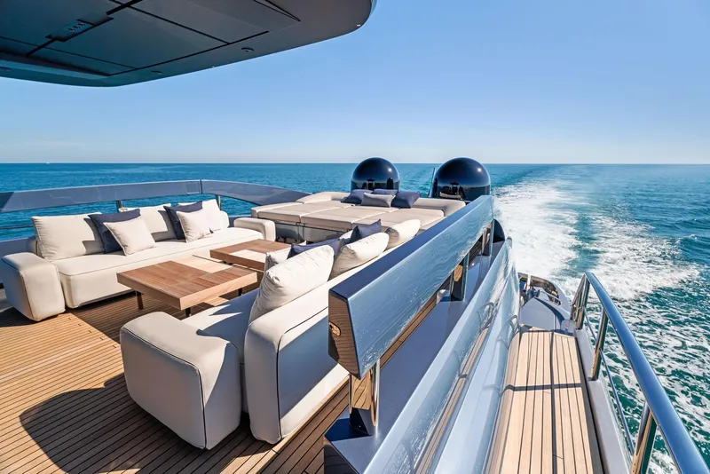 Slide: The Image of Luxurious 2023 Pershing GTX 116 yacht deck with elegant seating, cruising on open sea. - 23