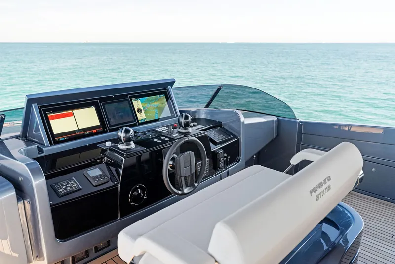 Slide: The Image of 2023 Pershing GTX 116 yacht helm with advanced navigation systems, overlooking the ocean. - 28