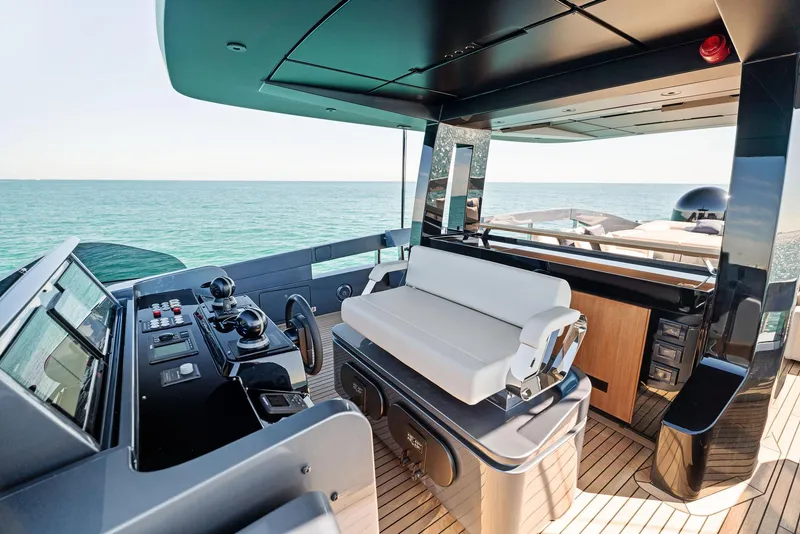 Slide: The Image of Luxurious 2023 Pershing GTX 116 yacht cockpit with modern controls and seating, overlooking the ocean. - 29