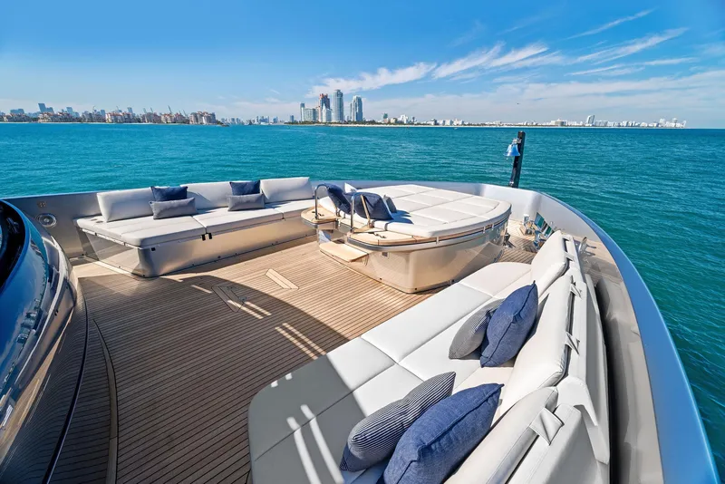 Slide: The Image of Luxurious 2023 Pershing GTX 116 yacht deck with elegant seating, ocean view, and city skyline. - 34