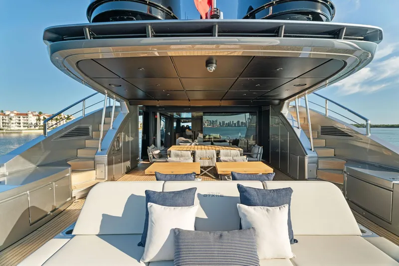 Slide: The Image of Luxurious 2023 Pershing GTX 116 yacht deck with elegant seating and scenic waterfront view. - 38