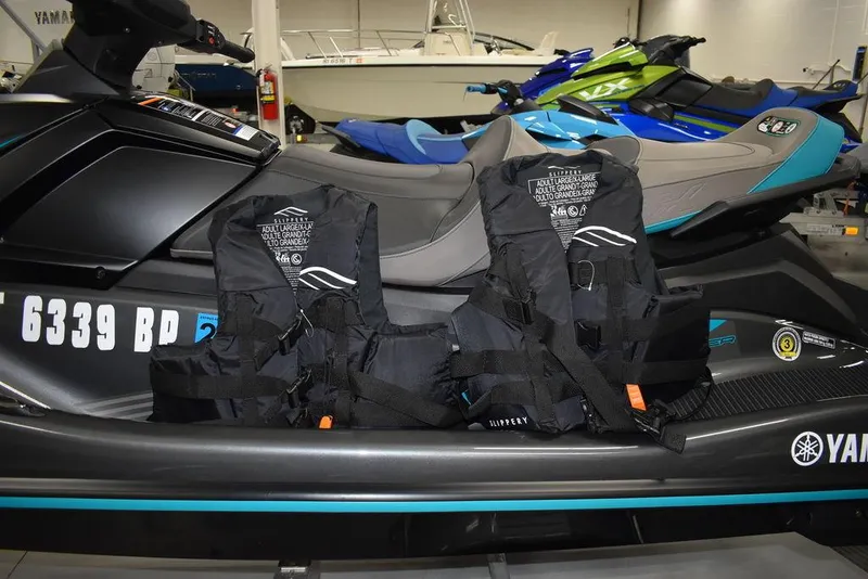 Slide: The Image of 2023 Yamaha WaveRunner VX Cruiser with life jackets, displayed in a showroom. - 28