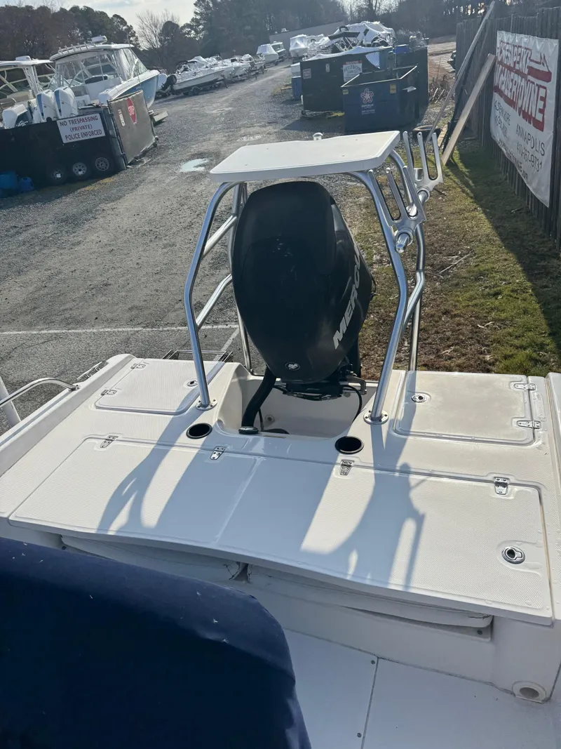 Slide: The Image of 2009 Boston Whaler 180 Dauntless boat, rear view with motor, parked outdoors. - 2