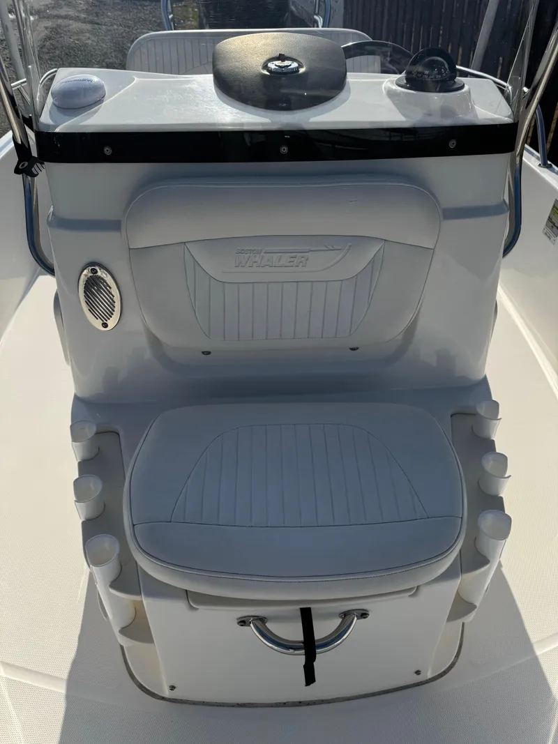 Slide: The Image of 2009 Boston Whaler 180 Dauntless boat console with seating and storage. - 4