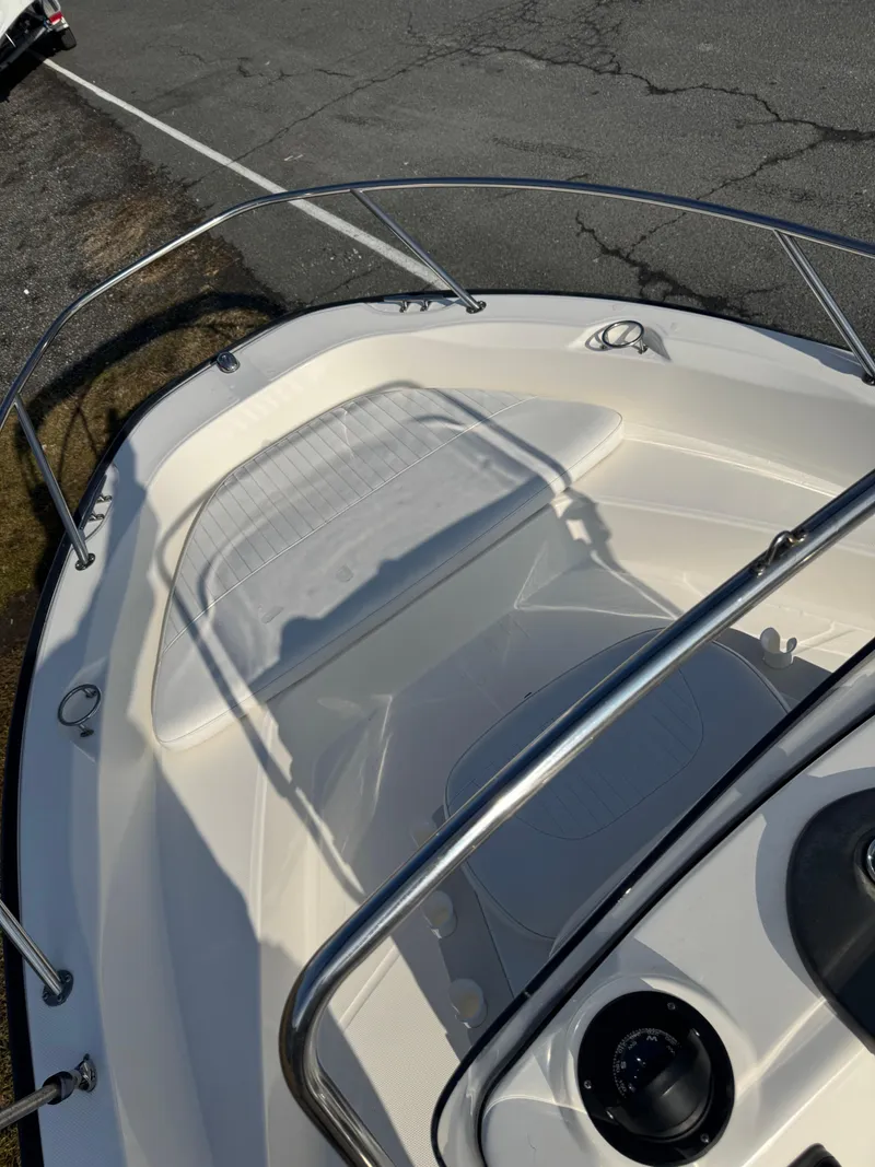 Slide: The Image of 2009 Boston Whaler 180 Dauntless boat deck with railings and seating area. - 5