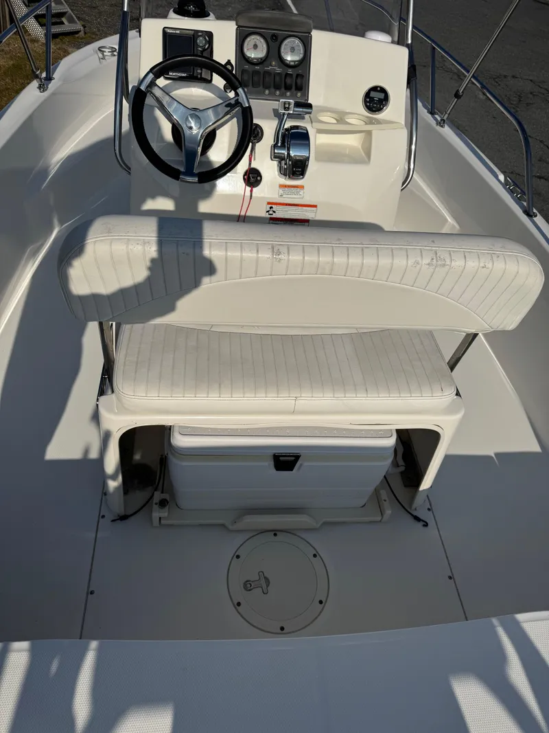 Slide: The Image of 2009 Boston Whaler 180 Dauntless boat interior with steering wheel and seating. - 6