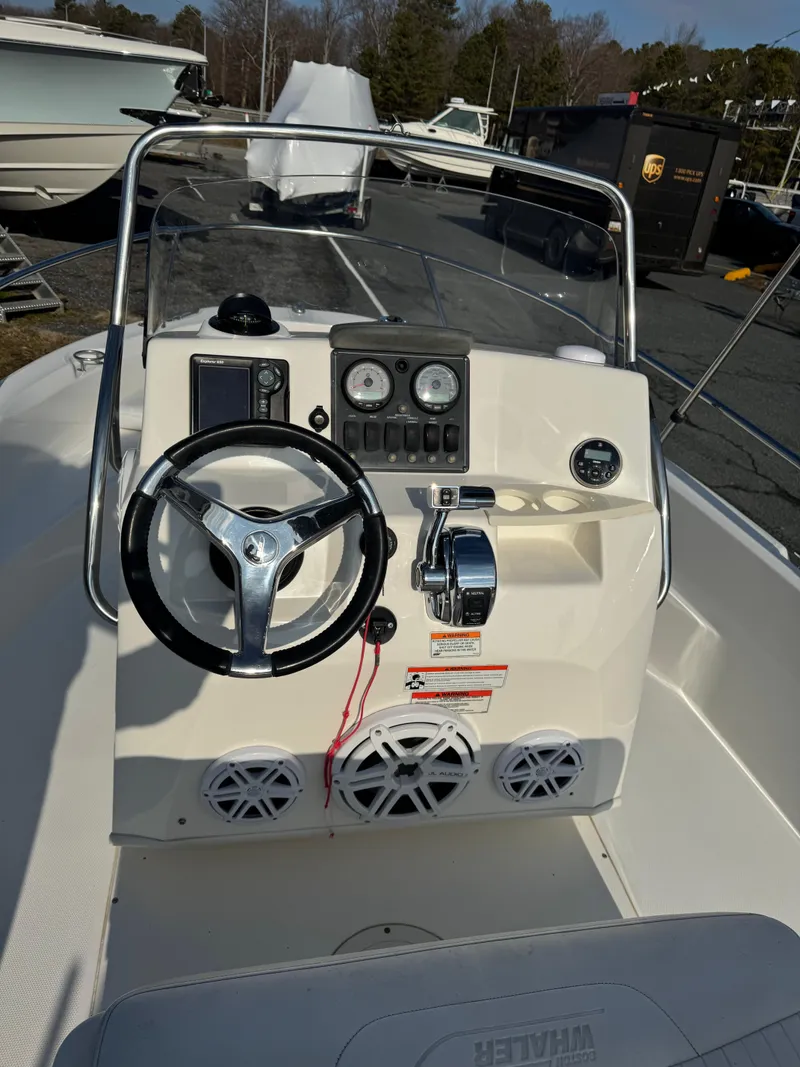 Slide: The Image of 2009 Boston Whaler 180 Dauntless boat console with steering wheel and controls. - 8