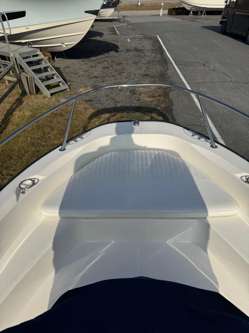 Slide: The Image of 2009 Boston Whaler 180 Dauntless boat bow view in a marina setting. - 9