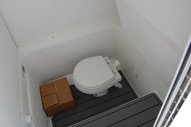 Slide: The Image of 2025 Cape Horn 28XS boat interior with toilet and storage box. - 16