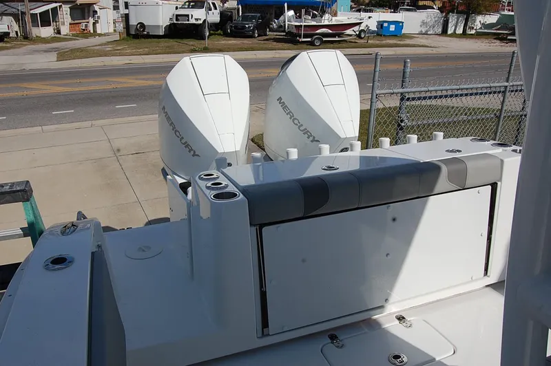 Slide: The Image of 2025 Cape Horn 28XS boat with dual Mercury engines, docked near a road. - 6