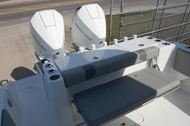 Slide: The Image of 2025 Cape Horn 28XS boat with dual Mercury engines and cushioned seating. - 7