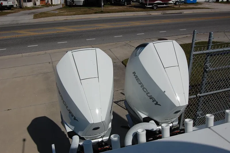 Slide: The Image of Twin Mercury outboard engines on a 2025 Cape Horn 28XS boat, parked near a road. - 5