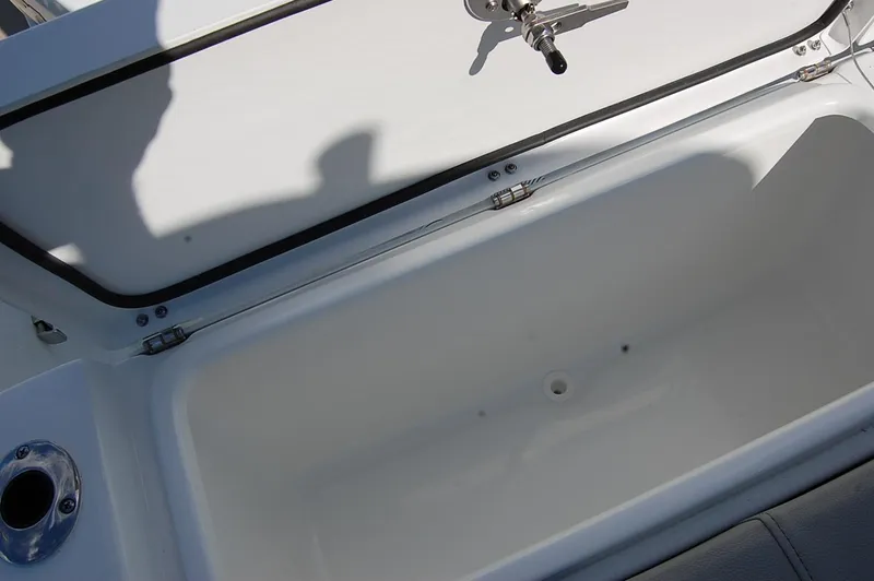 Slide: The Image of 2025 Cape Horn 28XS boat storage compartment, open lid, white interior. - 9