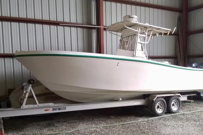 The Image of 1996 Mako 262 Center Console boat on trailer in storage facility. - 0