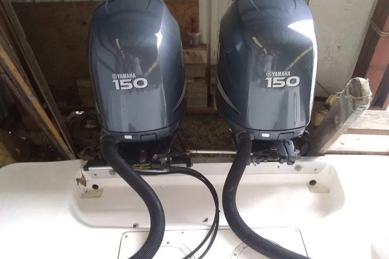 Slide: The Image of Twin Yamaha 150 outboard engines on a 1996 Mako 262 Center Console boat. - 11