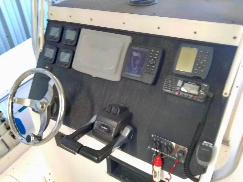 Slide: The Image of 1996 Mako 262 Center Console dashboard with steering wheel and navigation instruments. - 5