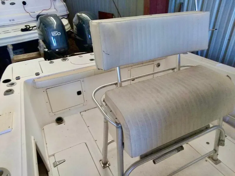 Slide: The Image of 1996 Mako 262 Center Console boat with dual 150 horsepower engines and seating. - 7