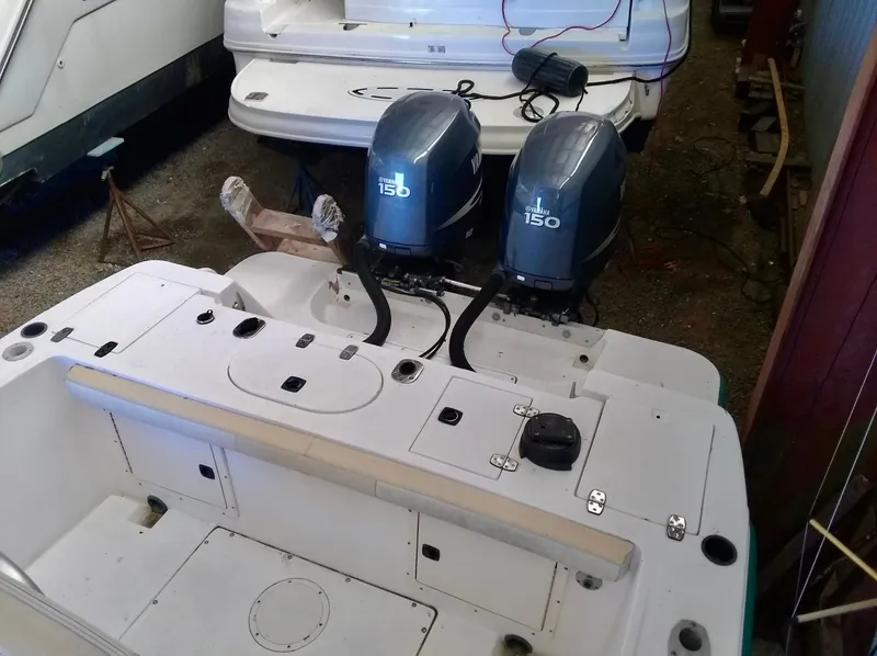 Slide: The Image of 1996 Mako 262 Center Console boat with dual 150 horsepower outboard engines. - 9