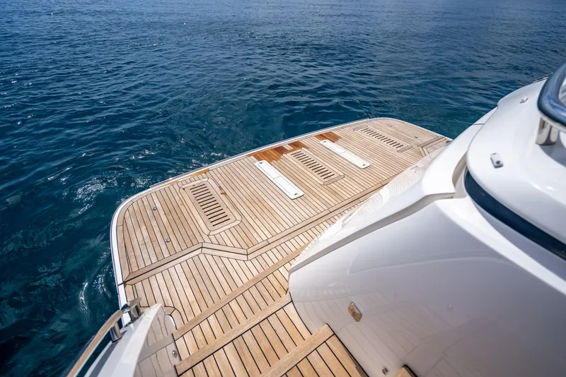 Slide: The Image of 2023 Princess F65 yacht with teak deck on calm blue water. - 11