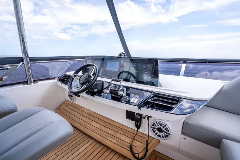 Slide: The Image of Modern helm of 2023 Princess F65 yacht with advanced navigation controls and sleek design. - 20
