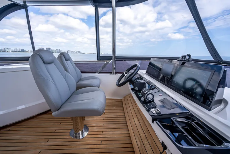 Slide: The Image of 2023 Princess F65 yacht cockpit with modern controls and luxurious seating. - 21