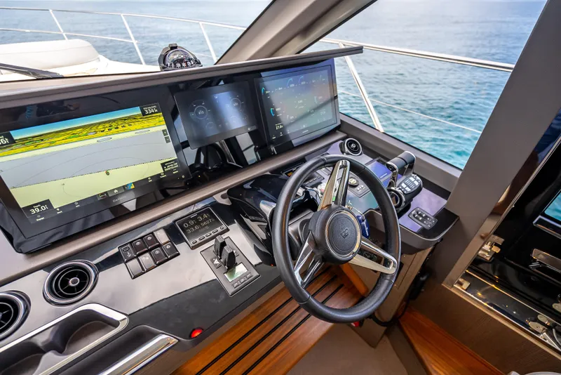 Slide: The Image of 2023 Princess F65 yacht helm with advanced navigation displays and controls, overlooking the ocean. - 27