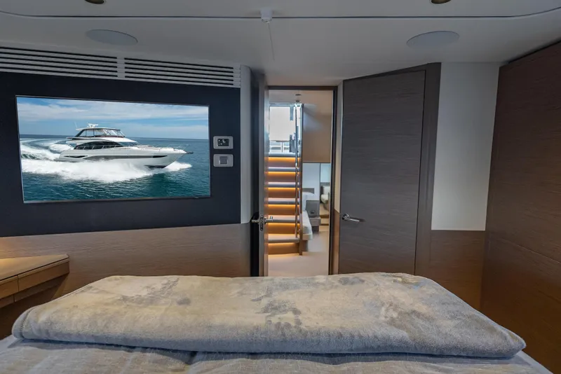 Slide: The Image of Luxurious interior of 2023 Princess F65 yacht with modern decor and TV display. - 42