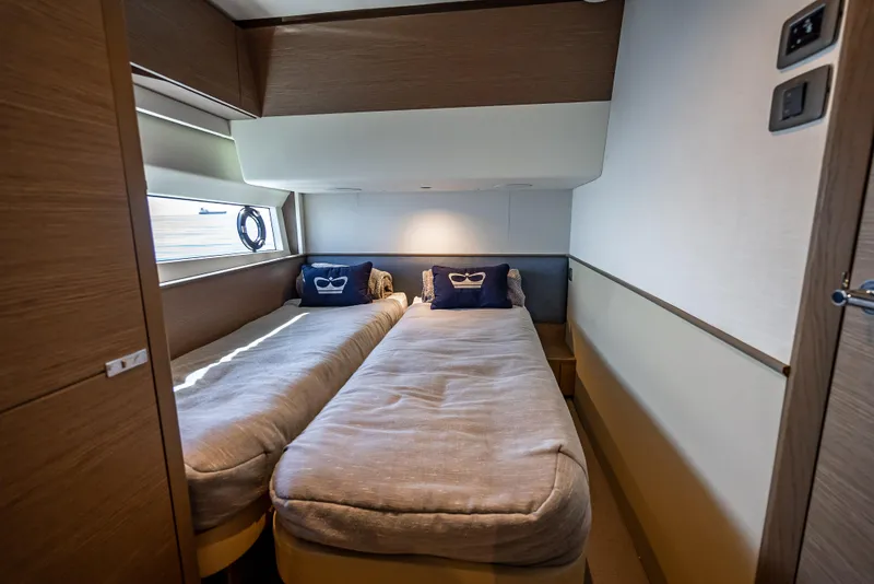 Slide: The Image of 2023 Princess F65 yacht cabin with twin beds and nautical decor. - 46