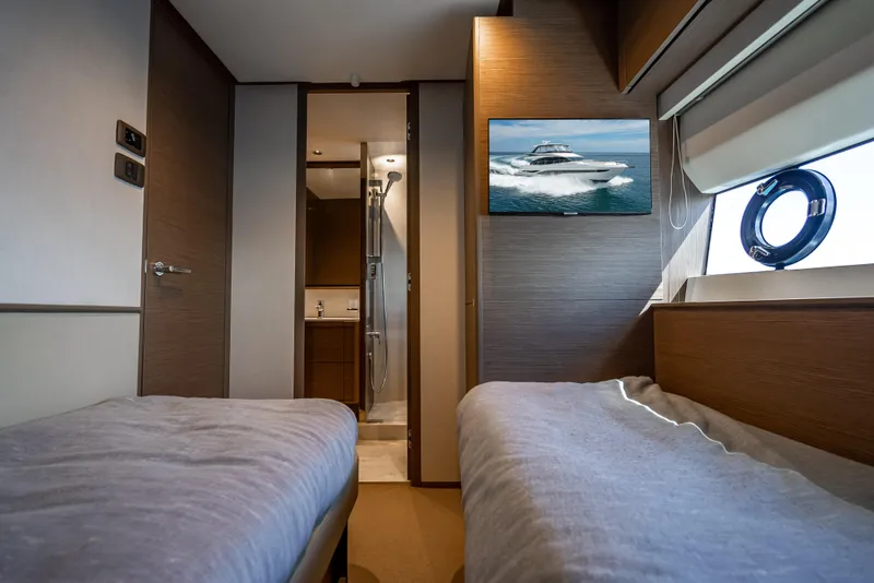 Slide: The Image of Interior of 2023 Princess F65 yacht cabin with twin beds and ensuite bathroom. - 48