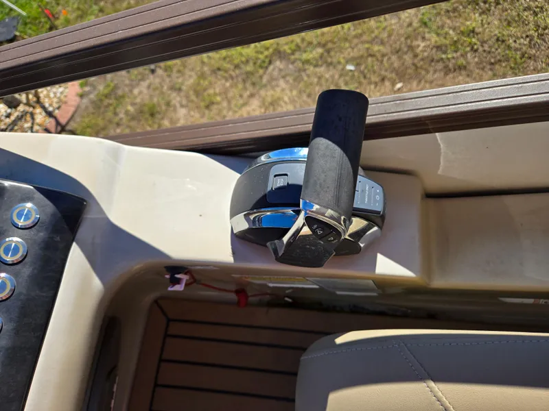 Slide: The Image of Close-up of 2017 Regency 254 LE3 boat throttle control on deck. - 12