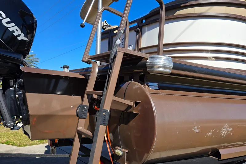 Slide: The Image of 2017 Regency 254 LE3 pontoon boat with ladder and Mercury engine. - 2