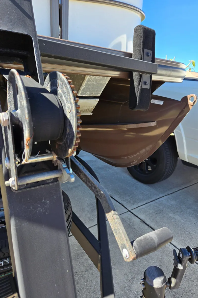 Slide: The Image of Close-up of a 2017 Regency 254 LE3 boat trailer winch and hull. - 20