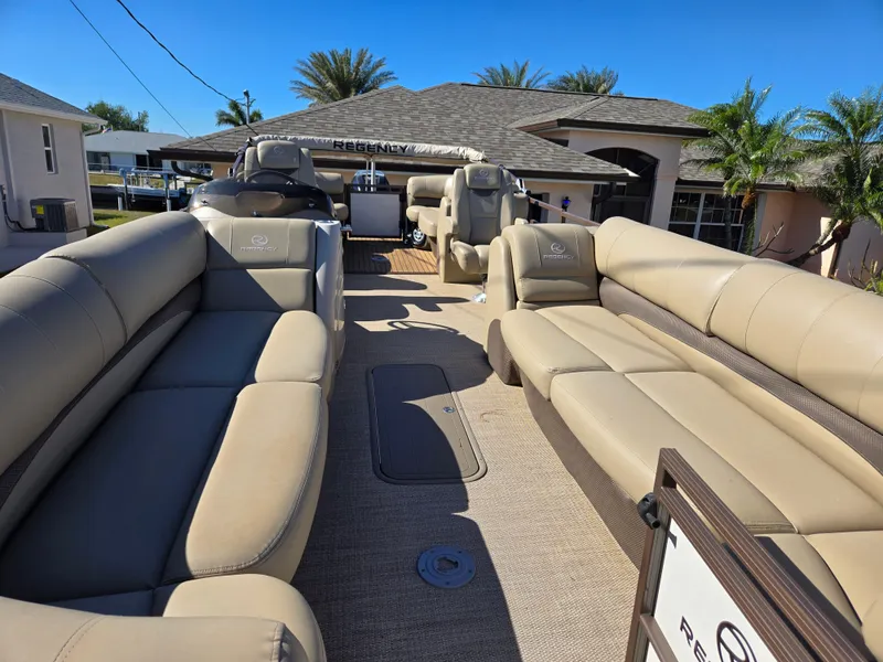 Slide: The Image of 2017 Regency 254 LE3 pontoon boat with beige seating and spacious deck. - 3