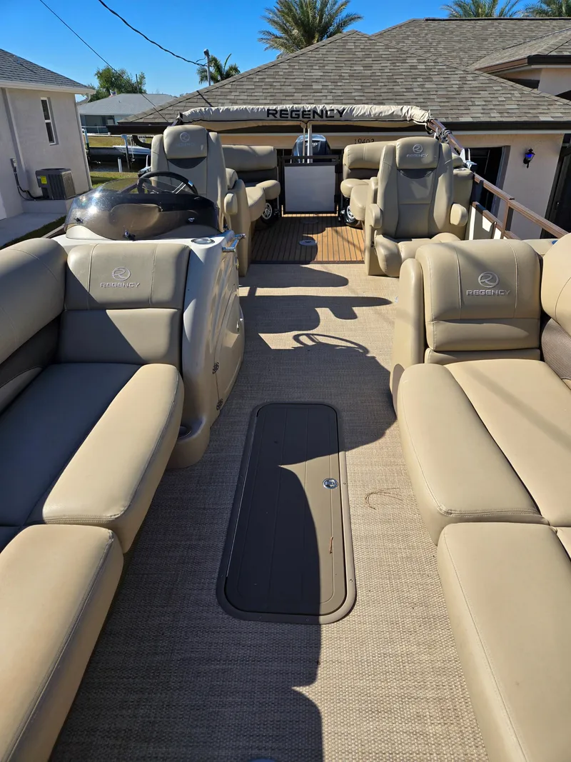 Slide: The Image of 2017 Regency 254 LE3 pontoon boat with beige seating and spacious deck. - 4