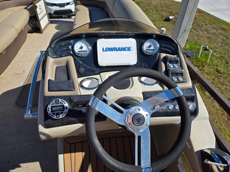 Slide: The Image of 2017 Regency 254 LE3 boat dashboard with Lowrance display and steering wheel. - 6