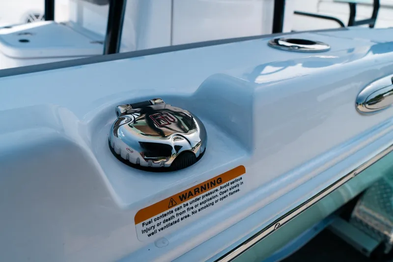 Slide: The Image of 2025 Caymas 28 HB boat fuel cap with warning label, close-up view. - 10