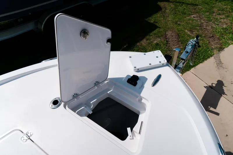 Slide: The Image of 2025 Caymas 28 HB boat with open storage compartment on deck. - 12