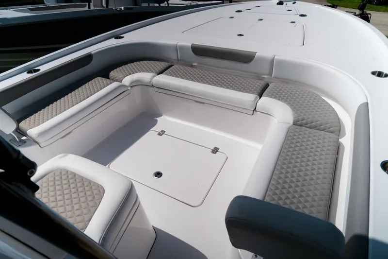 Slide: The Image of 2025 Caymas 28 HB boat interior with cushioned seating and storage compartment. - 15