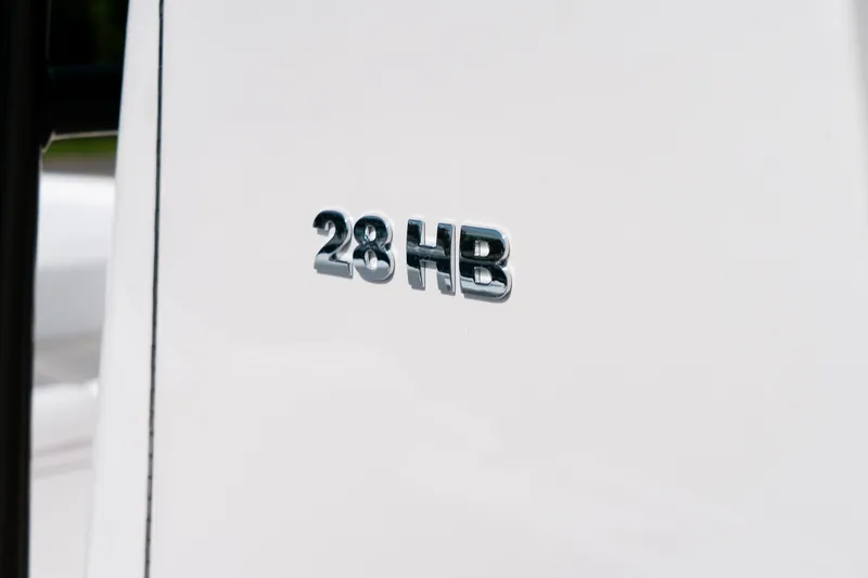 Slide: The Image of 2025 Caymas 28 HB emblem on sleek white surface. - 20