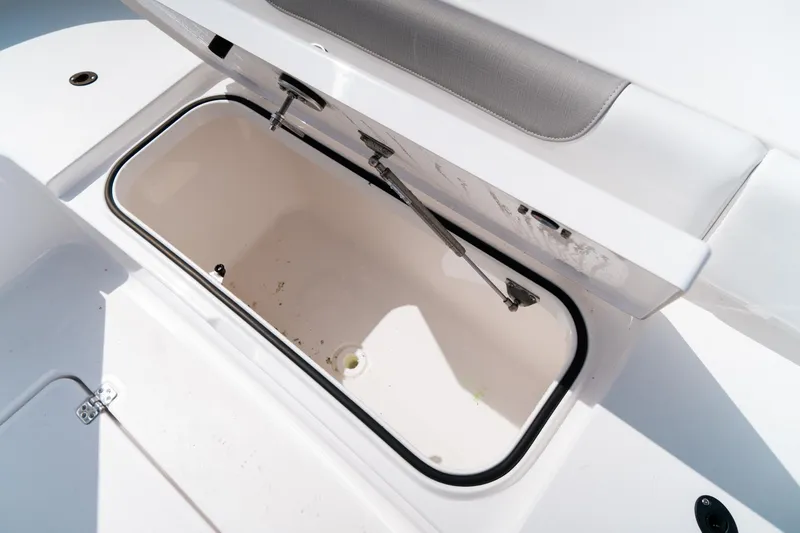 Slide: The Image of 2025 Caymas 28 HB boat storage compartment with open lid, showcasing interior space. - 27