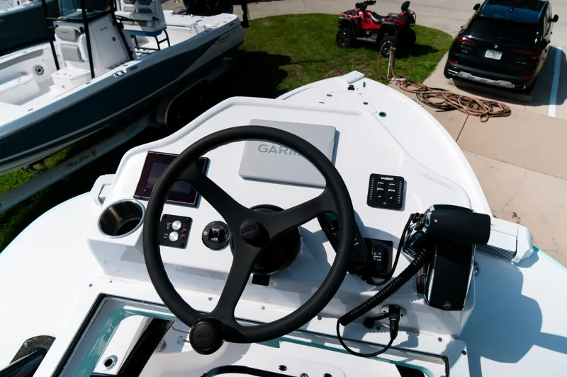 Slide: The Image of Helm of 2025 Caymas 28 HB boat with modern controls and Garmin display. - 33